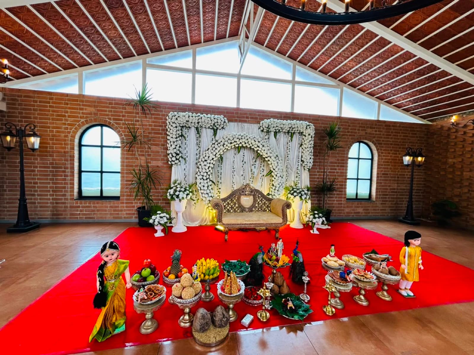 White floral arch with traditional platters