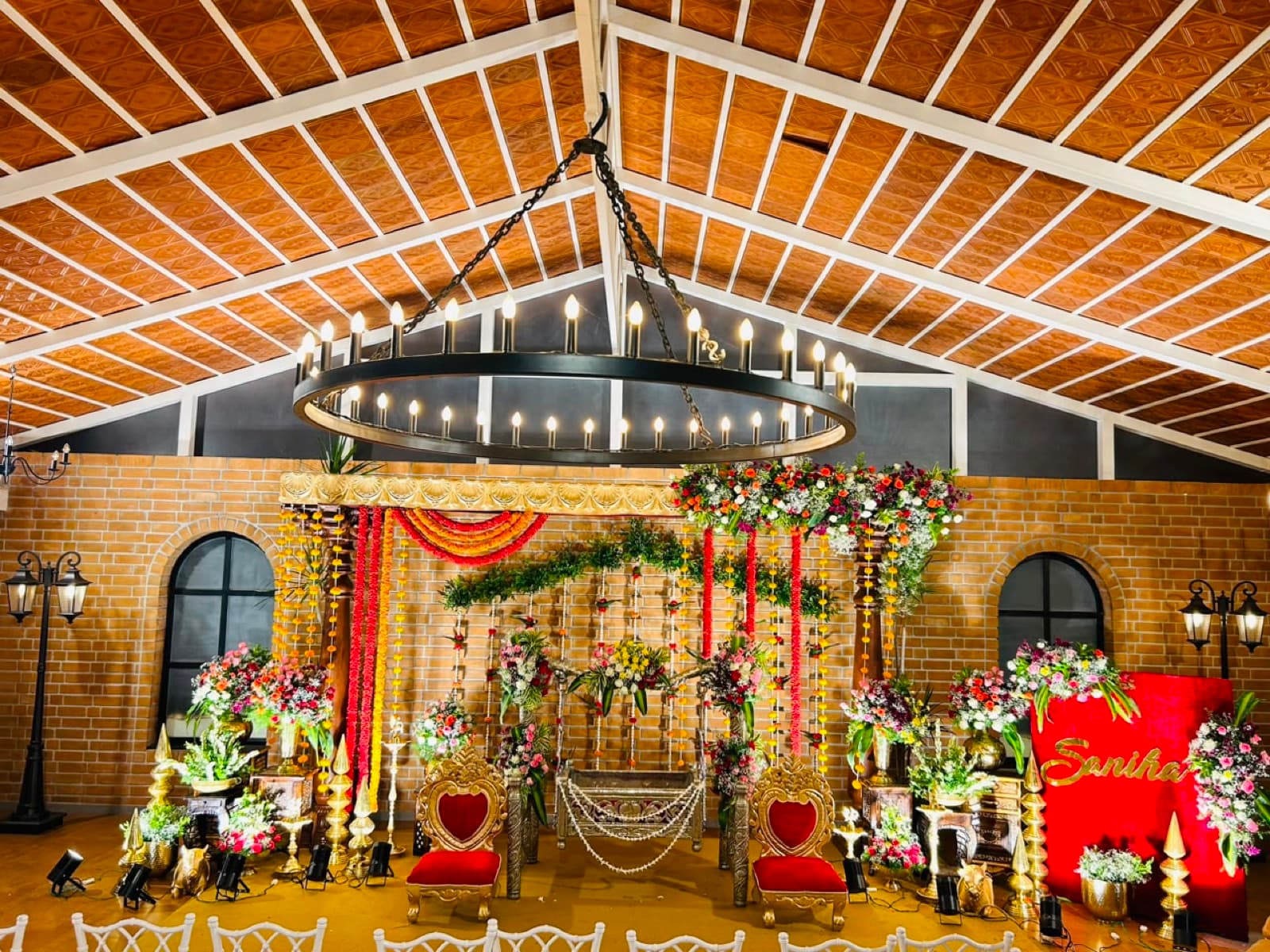 Cozy Corner hall with a floral mandap under the chandelier